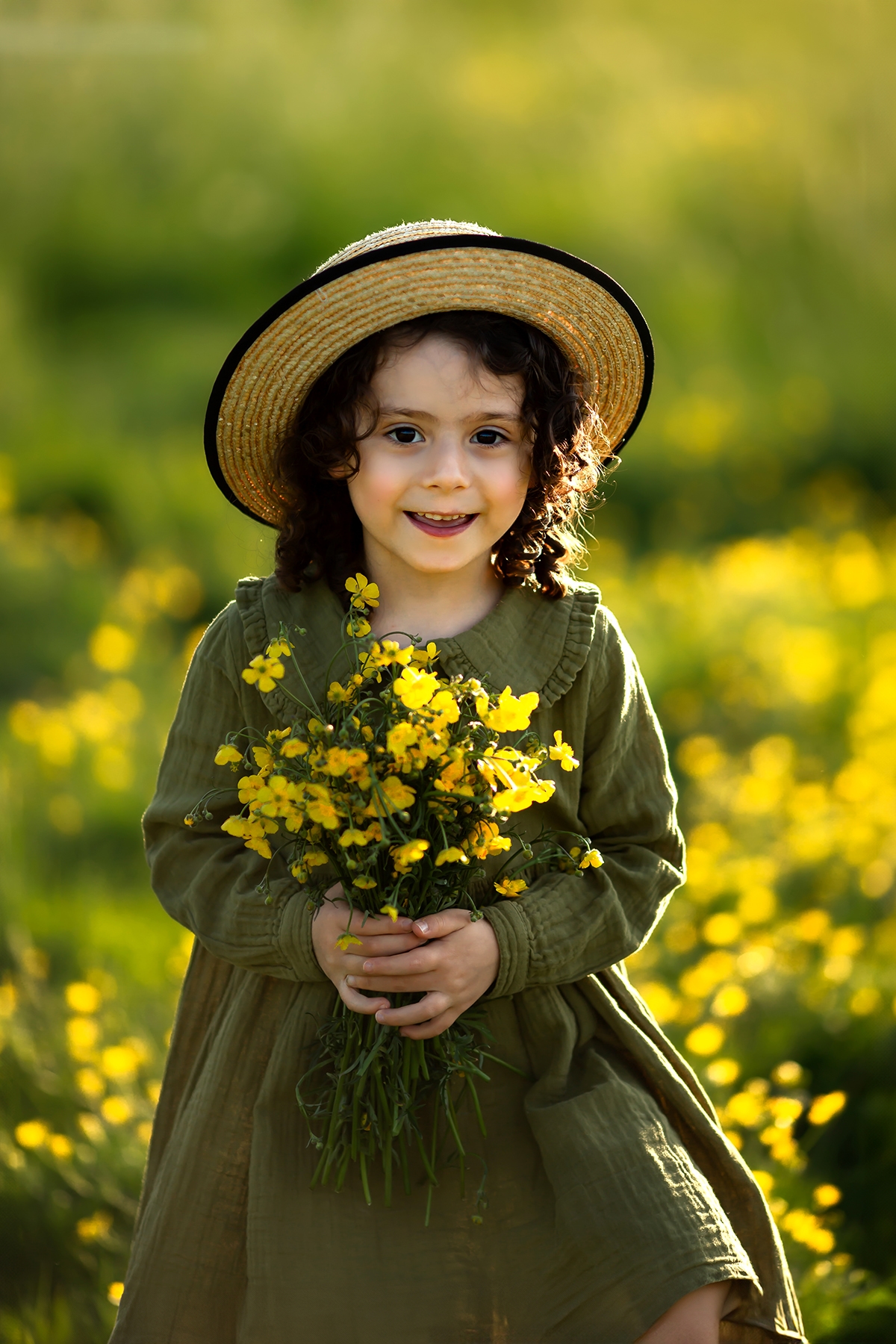 London Spring Family Mini Sessions | portrait of a girl holding a bunch of wildflowers and smiling