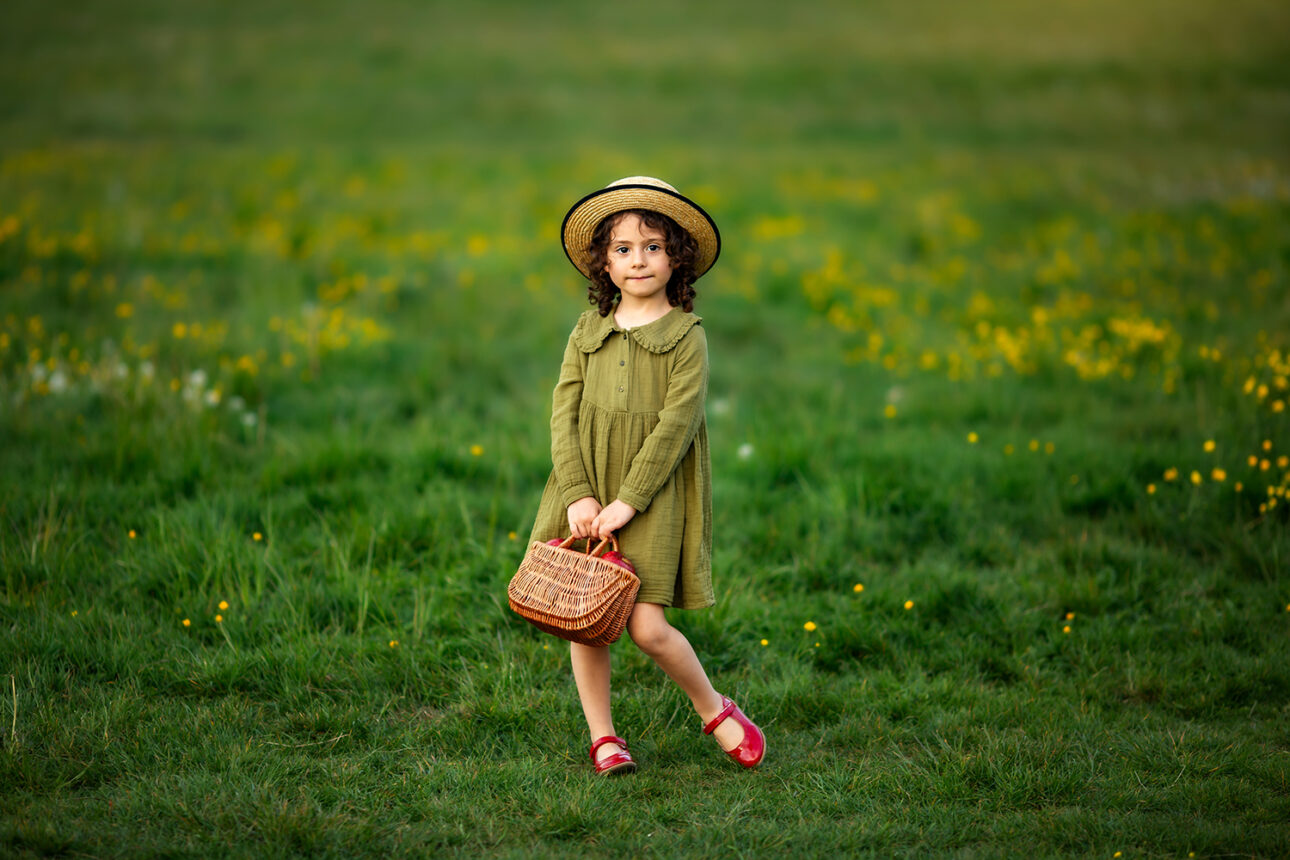 London Spring Mini Sessions | a portrait of a girl with a straw hat and a wicker basket taken in London park