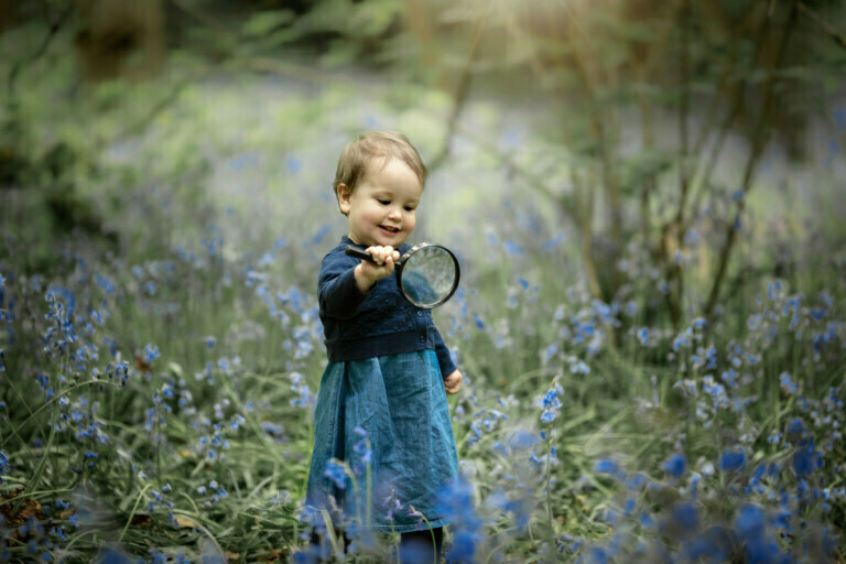 Spectacular Bromley Baby Bluebell Mini Session | Julia 7 Spectacular Bromley Baby Bluebell Mini Session | 1 year old baby girl plays with a magnifying glass watching bluebells