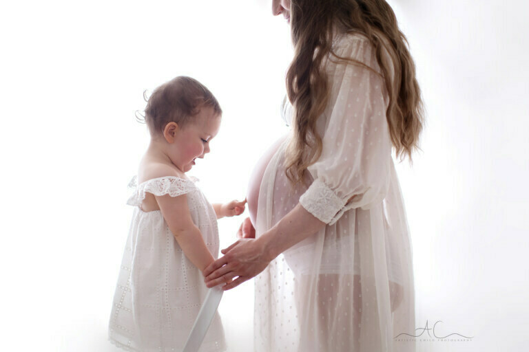 5 Beautiful South East London Maternity Photos | Paulina 3 5 Beautiful South East London Maternity Photos | photo of a monther and daughter pointing at her pregnant belly