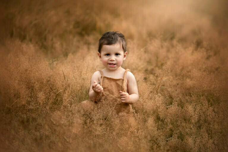 8 Best South East London Baby Boy Pictures | Jude 1 Best South East London Baby Boy Pictures | portrait of a 1 year old baby boy sitting in a long grass field