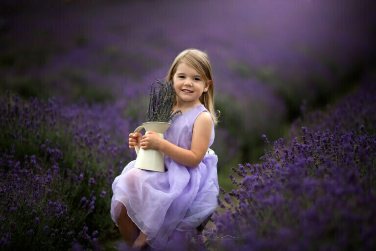 Best London Child Photoshoot in Lavender Field | Beatrice 16 Best London Child Photoshoot in Lavender Field | portrait of a 5 years old girl sitting on ladder steps in lavender field and holding a pot full of lavender flowers