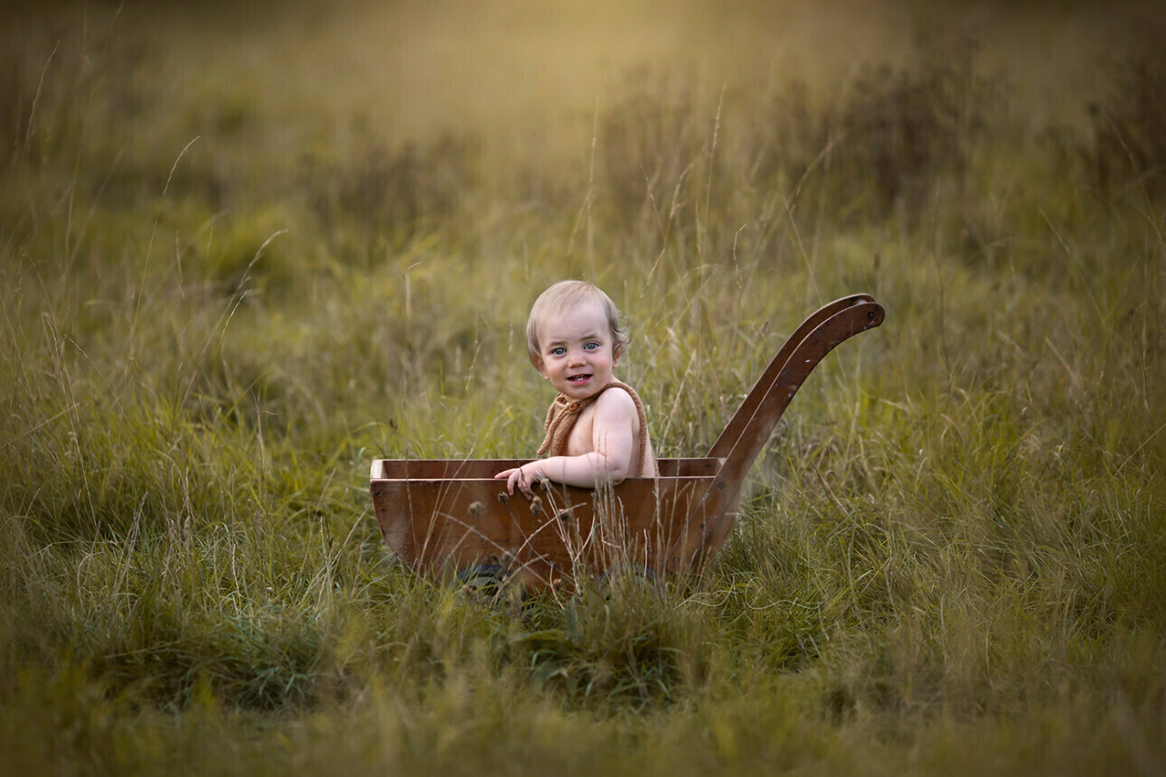 6 Gorgeous Bromley Toddler Pictures | Gabriel 2 portrait of a 1 year old toddler boy sitting in a wooden trolley | Bromley