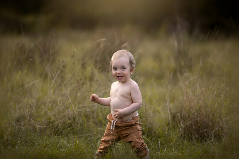 Gorgeous Bromley Toddler Pictures | 1 year old boy takes his first steps during a professional photo session in the park