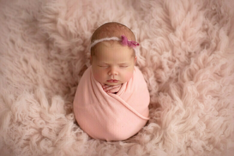 Beautiful Bromley Newborn Baby Images | photo of a newborn baby girl wearing a cute pink headtie