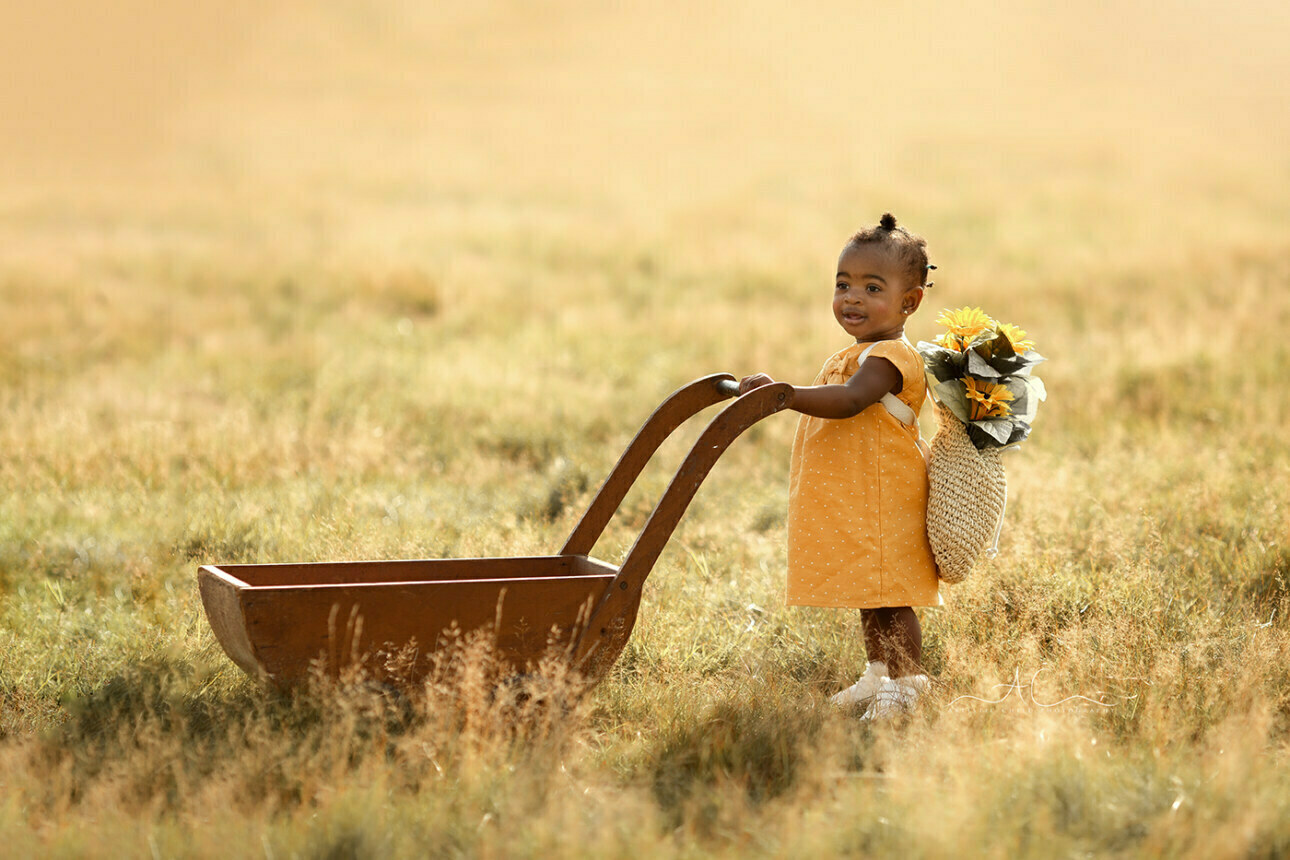 Beautiful London Toddler Photography | Dassah 4 Beautiful London Toddler Photography | 1 year old girl pushes a wooden trolley during a professional photoshoot
