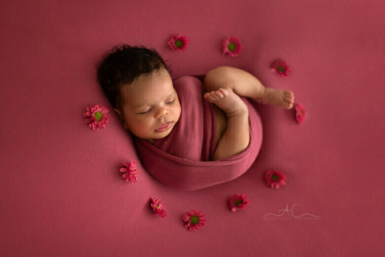 Best South East London Newborn Portraits | 5 weeks old baby girl sleeps surrounded by flowers during her newborn photo session