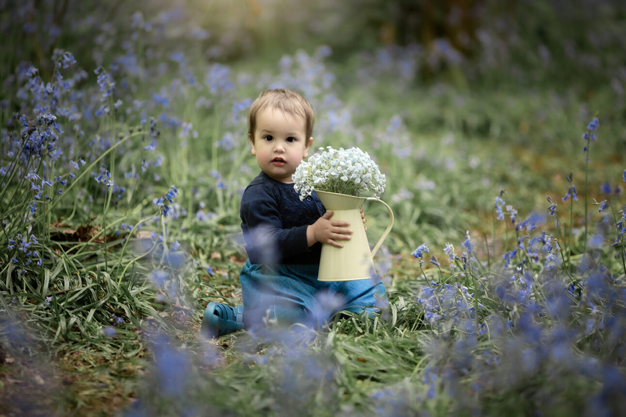 6 Magical London Toddler Bluebell Photos | Julia 2 portrait of 1 year old girl holding a vase of blue flowers | London