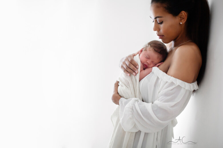 Best South East London Newborn Photographer | backlit portrait of Mum cuddling her newborn baby girl