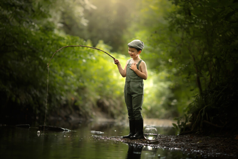 Magical London Children Portraits by the water | portrait of a 6 year old boy with a fishing rod taken by the water