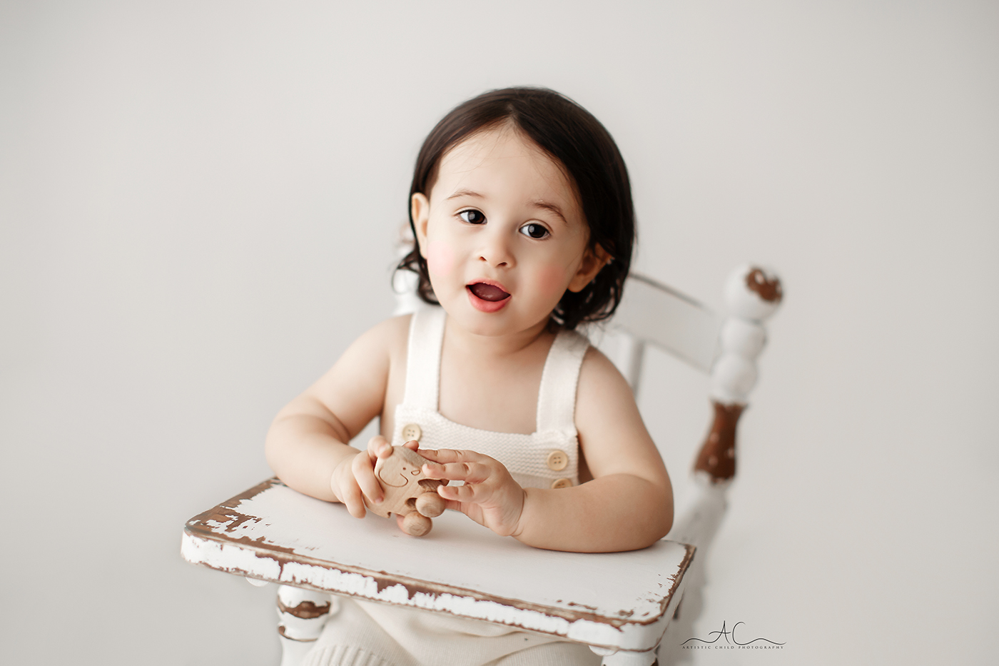 6 Stunning London Toddler Boy Pictures | Julian 3 18 months old boy plays with a little wooden elephant during his professional photoshoot in London