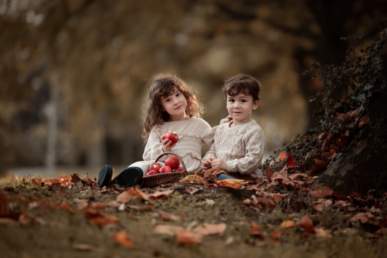 Stunning London Sibling Photo Session | portrait of a brother and sister sitting together under the trea