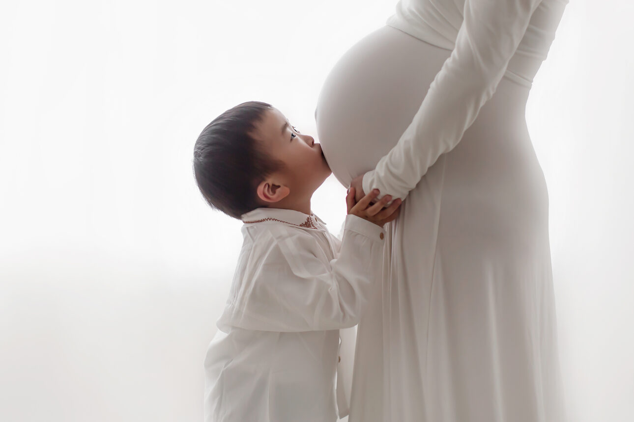 London Maternity Photography 16 London Maternity Photographer | photo of a 2 year old boy kissing her mum's pregnant belly