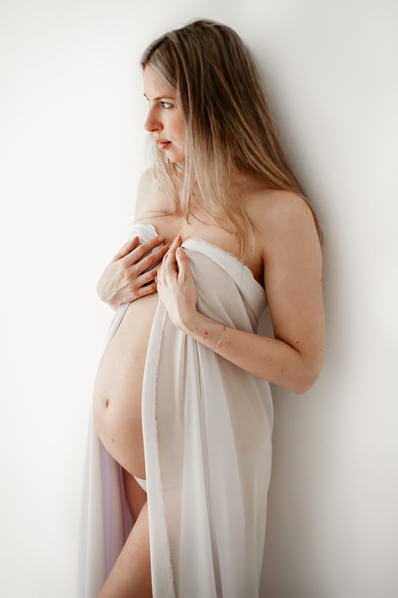 London Maternity Photography 5 London Maternity Photoshoot | maternity portrait showing a pregnant woman covered in a white fabric