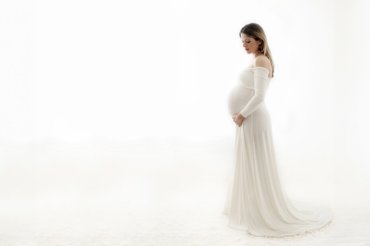 London Maternity Photography 14 London Maternity Photoshoot | pregnant woman in a white long maternity dress
