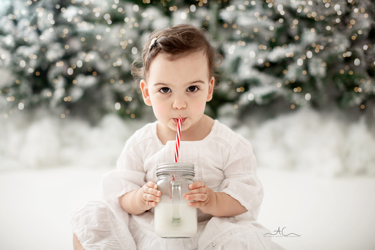 London Christmas Photoshoot | baby girl drinking milk during Xmas photoshoot