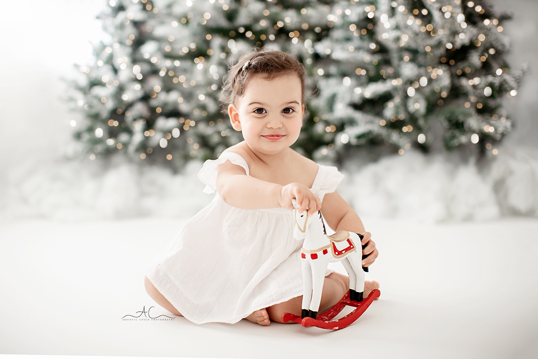 London Christmas Photoshoot | baby girl playing with Xmas toy