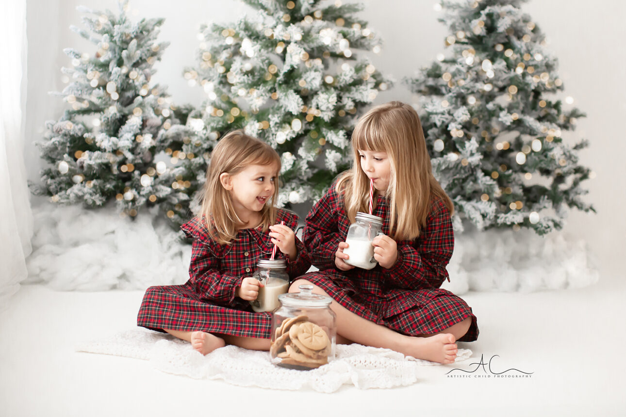 London Christmas Photoshoot | sisters drinking milk and eating cookies during their Xmas photo session