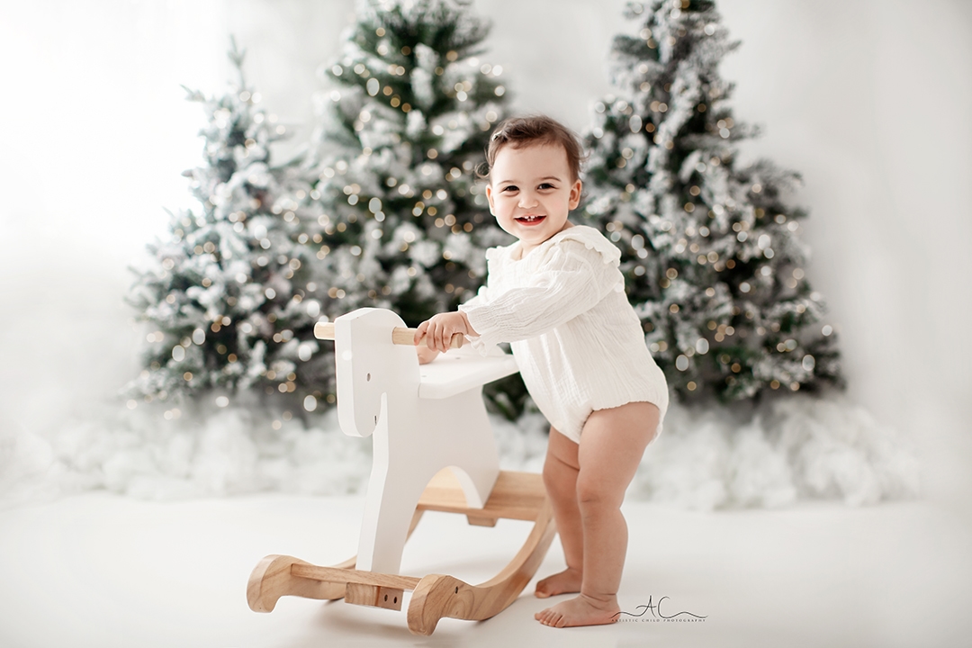 London Christmas Photoshoot | baby girl playing with a rocking horse