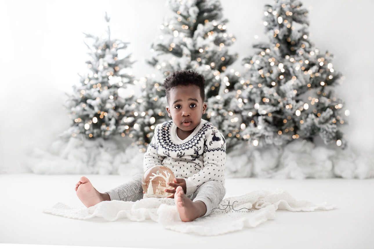 London Christmas Photoshoot | toddler boy playing with Xmas snow bowl
