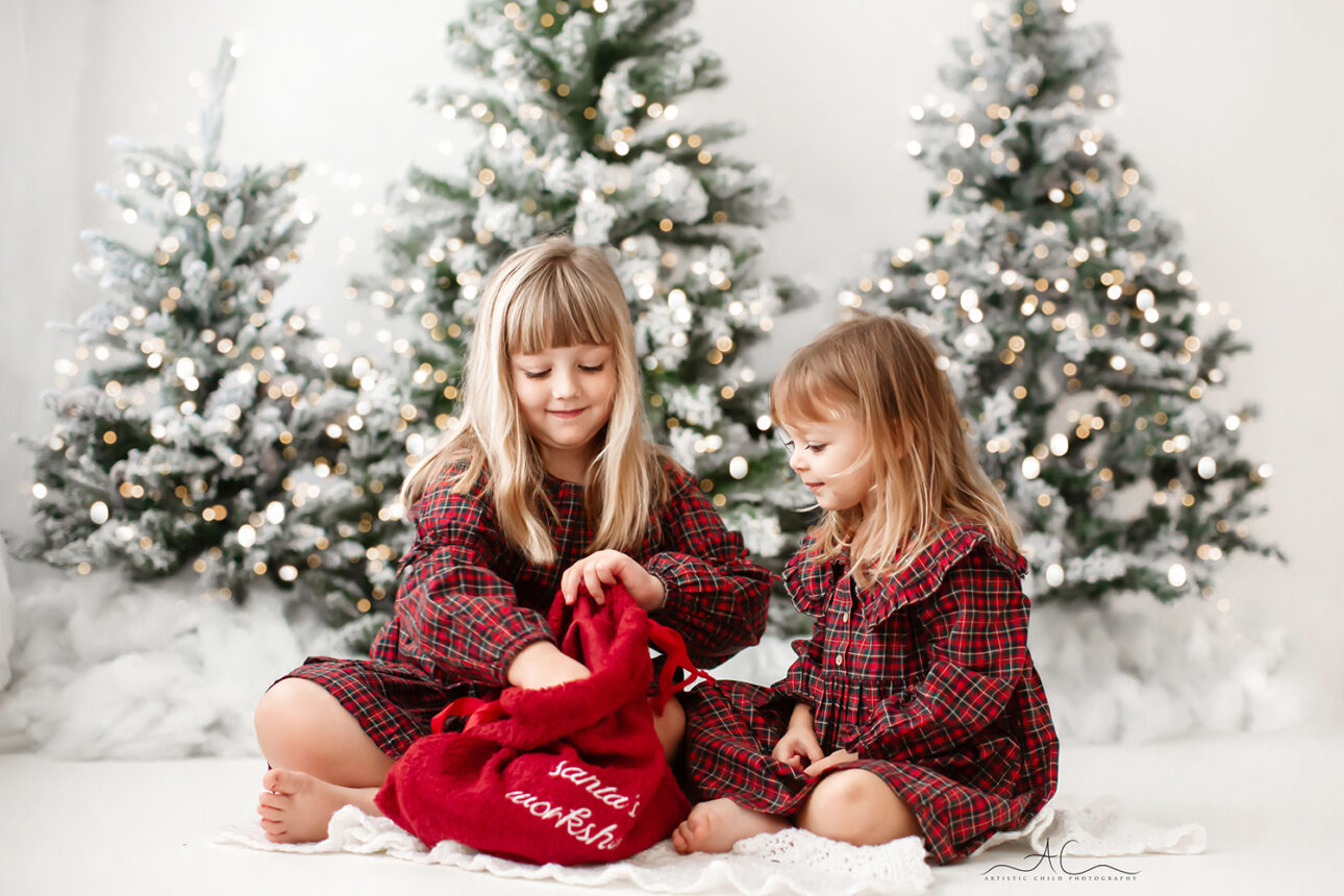 London Christmas Photoshoot | Xmas portrait of sisters opening Santa's sack