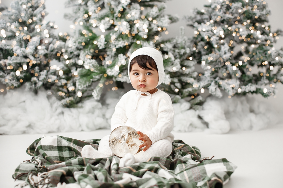 London Christmas Photoshoot | baby boy playing with Xmas snow bowl