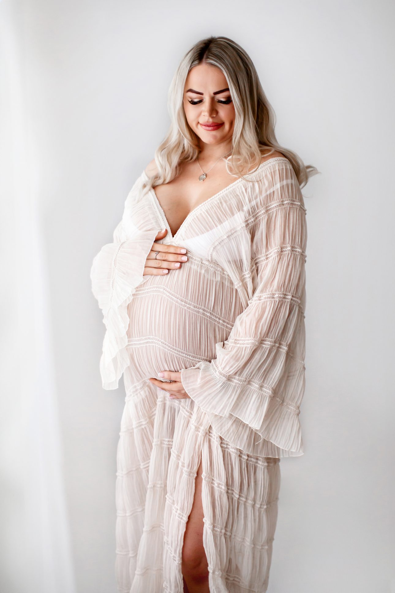 Bromley Maternity Photographer 8 Bromley Maternity Photographer | portrait of a mum to be looking gently at her bump
