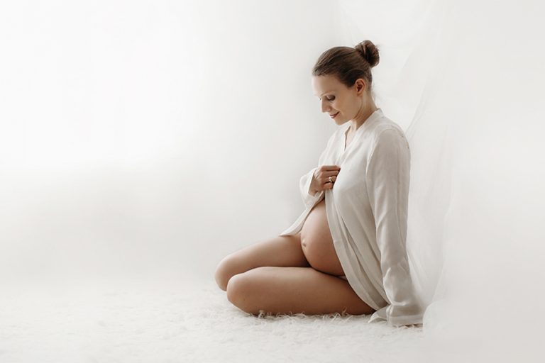 Bromley Maternity Photographer 1 Bromley Maternity Photographer | compelling portrait of an expecting mother wearing a while shirt.